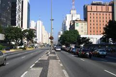 Avenida Paulista street with people, cars and tall buildings