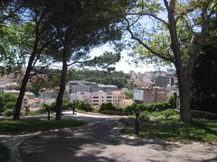 Scenic view of Jardim do Torel garden with lush trees and a walking path in Lisbon