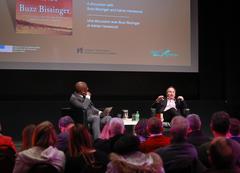 Buzz Bissinger speaking alongside professor Adrian Harewood at Canadian War Museum