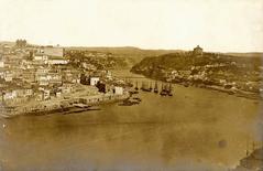 Historic view of Porto city along the Ribeira district with the suspended bridge in the background, painted in 1870-71