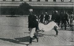 Public Force member carrying an injured civilian for medical assistance