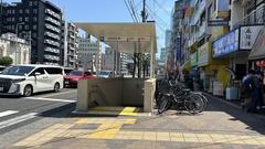 Entrance of Dobutsuen-mae Station Osaka Metro with signs and commuters