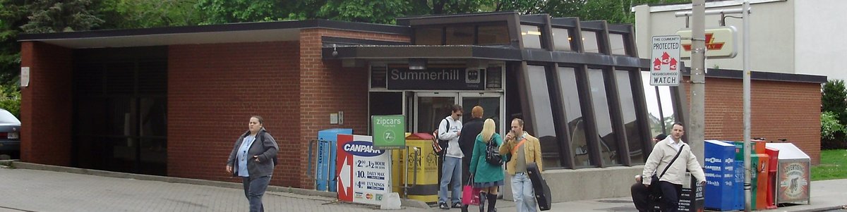Summerhill TTC station exterior in Toronto with train tracks and greenery
