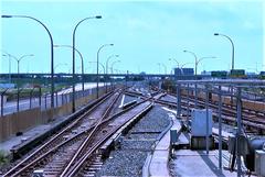 Surface crossover at Wilson subway station showing railway tracks and signaling equipment on a cloudy day
