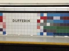 Interior view of Dufferin Toronto subway station with multicoloured tiled walls