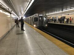 Westbound subway train arriving at Keele Subway Station on a sunny day