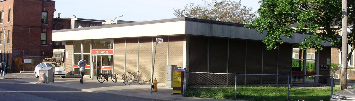Toronto Transit Commission Greenwood subway station building with a TTC bus undergoing repairs