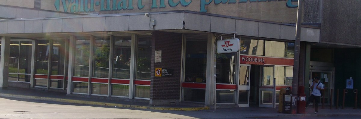 Toronto Transit Commission Woodbine station entrance with partial signage of adjacent Valu-Mart store