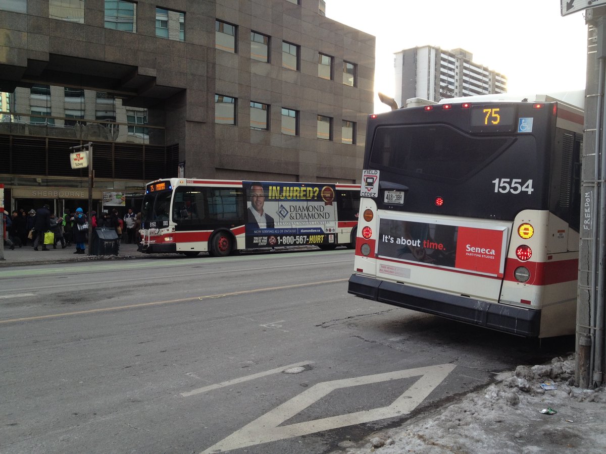 Two TTC buses outside Sherbourne Subway station in Toronto