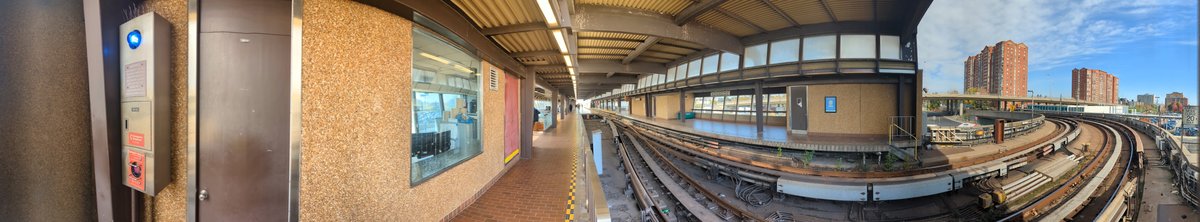 Panoramic view of TTC's Kennedy station platform with trains and passengers
