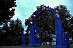 Blue Gate in an ancient stone wall with wooden door and gate tower