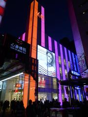 H&M store in Shinsaibashi at night with illuminated signage and modern storefront