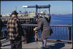 People engaging in various activities on McCorkle Fishing Pier at Castle Island Boston Harbor recreation area