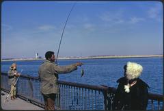 People engaging in activities on McCorkle Fishing Pier at Castle Island, Boston Harbor recreation area