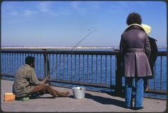 People engaging in various activities on McCorkle Fishing Pier at Castle Island Boston Harbor recreation area