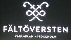 Fältöversten sign on a building facade with a clear blue sky