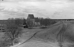 Ancient burial mounds with a church in the background at Gamla Uppsala, photo from the 1940s