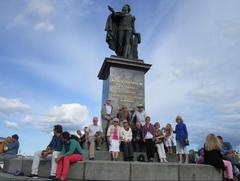 Family reunion of descendants of Andreas von Reis and Sara Aronsdotter at Gustav III statue in Skeppsbron Stockholm