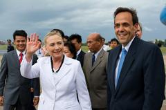 Secretary of State Hillary Rodham Clinton waving upon arrival at Phnom Penh International Airport with U.S. Ambassador William Todd