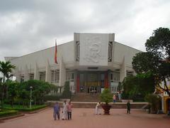 Exterior view of Ho Chi Minh Museum in Hanoi with distinctive conical roof and large glass walls