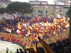 Ultras Catanzaro fan section full of supporters waving flags in the Curva Massimo Capraro