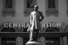Bronze statue of Nils Ericson outside Stockholm Central Station in black and white