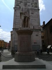 Historic view of Modena cityscape featuring traditional Italian architecture under a clear blue sky