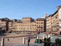 Panoramic view of Piazza del Campo in Siena with historic buildings and Torre del Mangia tower