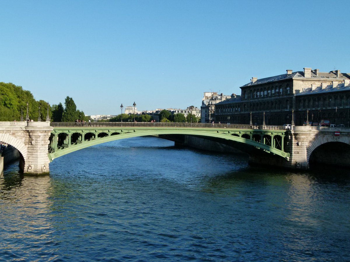 Le Pont Notre-Dame bridge over the Seine River in Paris with historic buildings on both sides