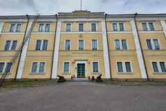 Naval Academy building on Suomenlinna island with historic architecture under clear blue sky