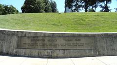 Dorchester Heights Monument entrance gate in a park with a stone pathway and green trees in Boston