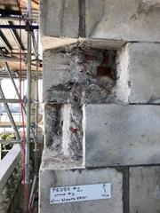 Corner of monument with marble chunks missing revealed by facade probe at Belfry level