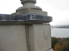 Close up of stone slab coming apart from monument with heaving stones and urns at Lantern Level