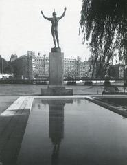 View of Strömparterren park with fishing nets and Milles sculpture 'Solsångaren' in front, Grand Hotel under renovation in background, 1950