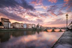Sunset over Florence cityscape with iconic red rooftops and historical buildings