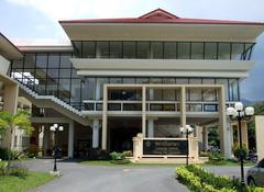 Chiang Mai University Language Institute building with modern architectural design and surrounding green trees under clear blue sky