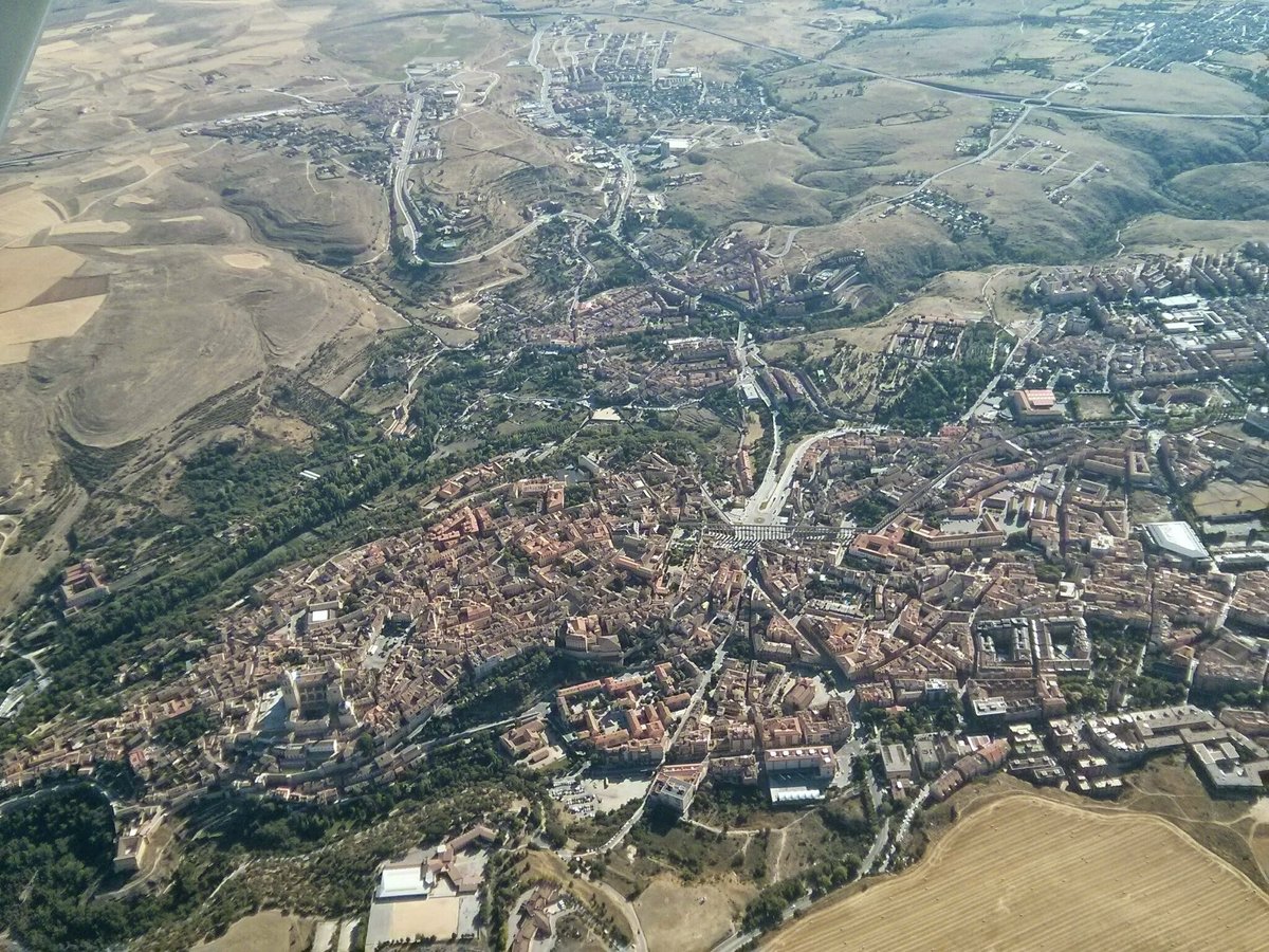 Aerial view of Segovia cityscape with historical buildings and surrounding landscape