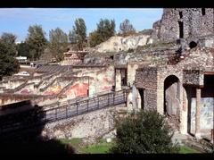 Suburban Thermae ruins in Pompeii with Porta Marina gate in the background