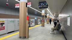 Sakaisuji-Hommachi Station platform of Osaka Metro with signs and safety barriers