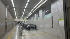 Osaka Metro underground connecting passage with escalators and advertisements