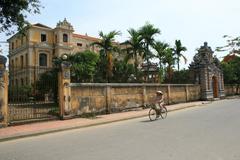 An Dinh Residence in Hue, Vietnam with traditional architecture surrounded by greenery