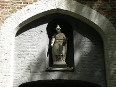 Saint Elisabeth statue niche above the entrance portal on the western facade of the Church of Beguinage in Bruges, Belgium