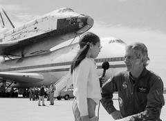 Astronaut Donald K. Deke Slayton interviewed by a young reporter at Kelly Air Force Base with space shuttle Columbia atop Shuttle Carrier Aircraft