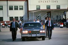 Secret service agents flanking the limousine transporting Pope John Paul II during his US visit