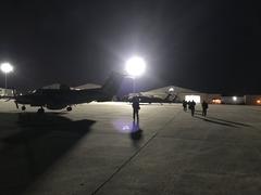 CBP Air and Marine Operations Multi-Role Enforcement Aircraft on tarmac with UH-60 Black Hawk Helicopter in background at Kelly Air Force Base