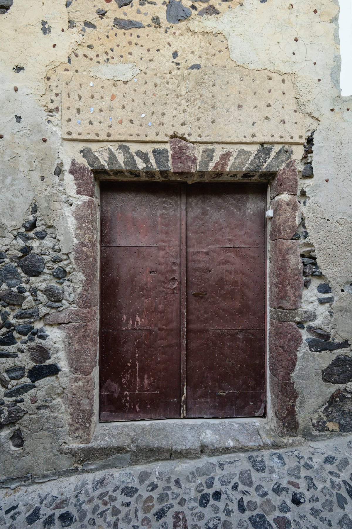 Old unused side entrance of Megaro Gyzi in Fira, Thira Municipality, Greece
