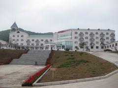 Maoershan Feidu Building surrounded by trees under a clear sky