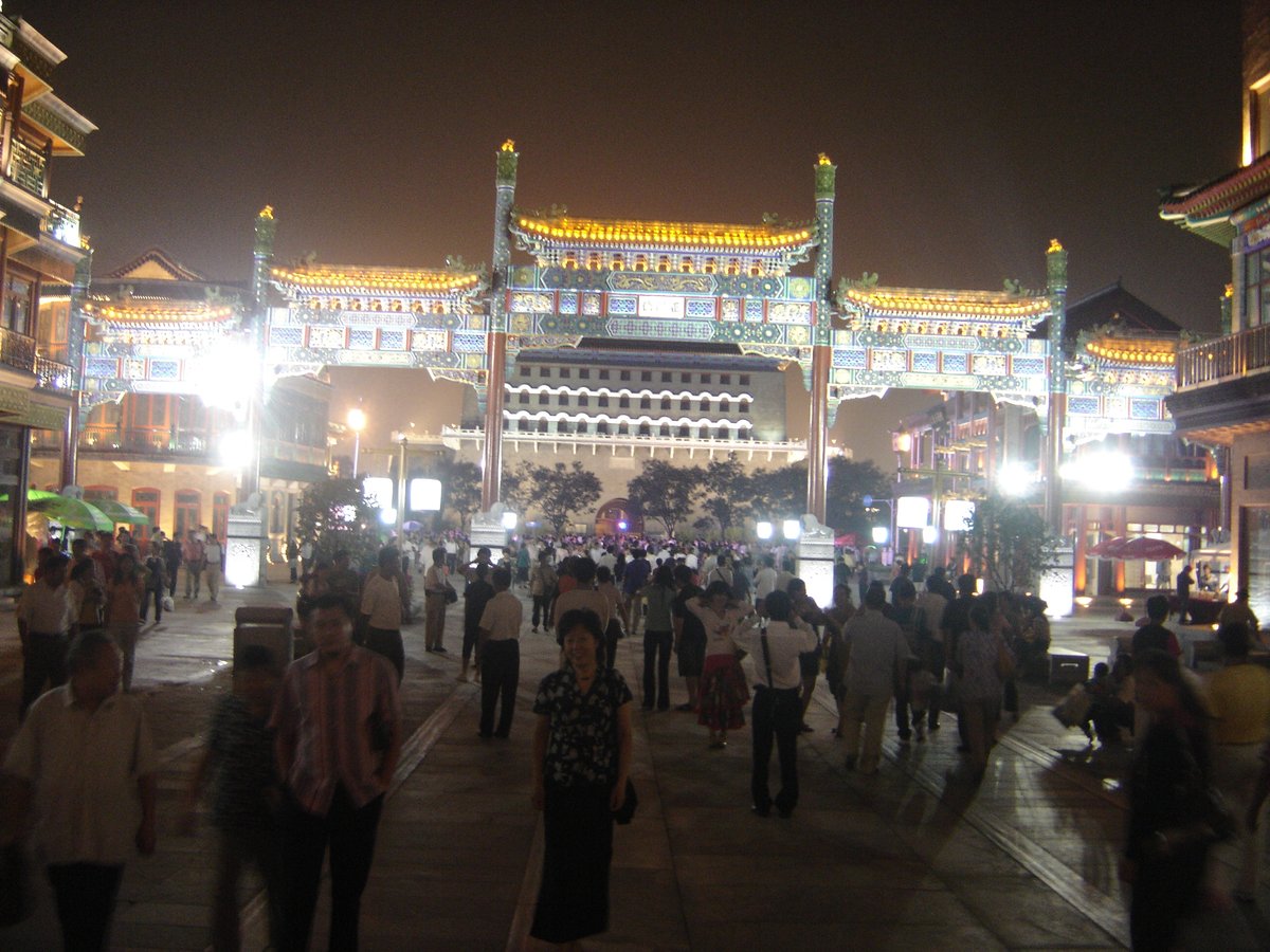 Qianmen Street in Beijing with traditional Chinese architecture and a bustling crowd