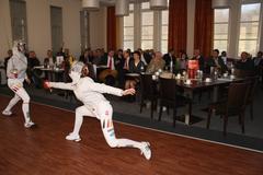 Students from Kaufmännische Schule Tauberbischofsheim performing show fencing at Rotary Club meeting