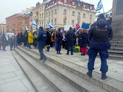 Pro-Israeli protest in Warsaw with demonstrators holding flags and banners